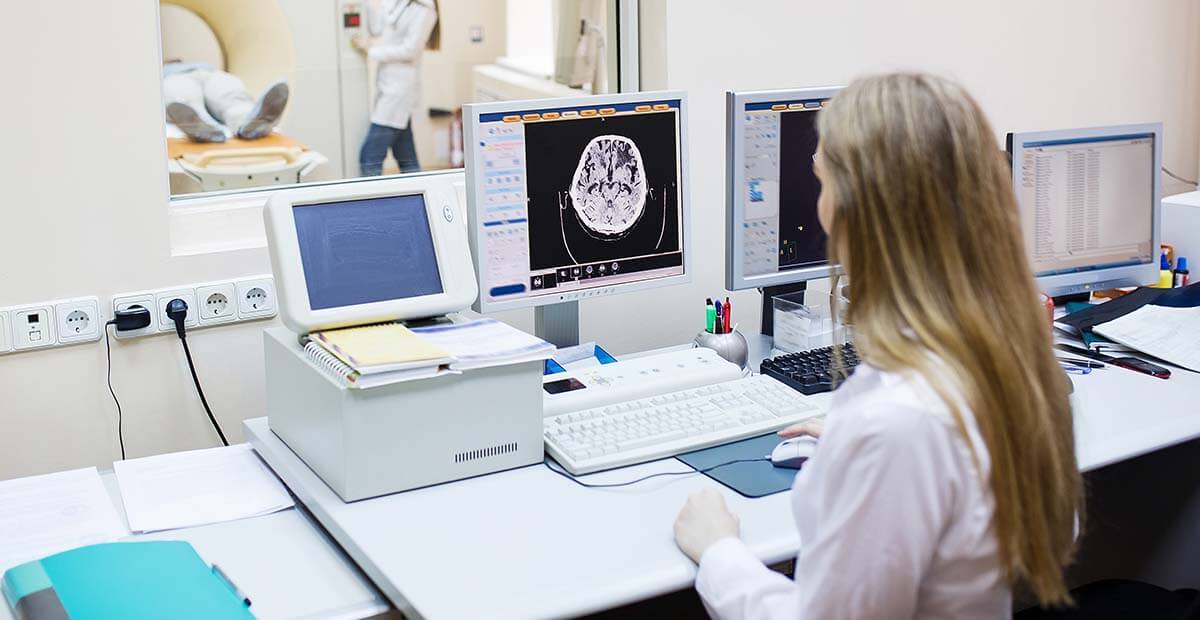 Radiologist analyzing scans from MRI machine